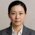 Sophisticated woman in professional business suit with neutral background, emphasizing confidence and leadership for corporate and professional SEO keywords.